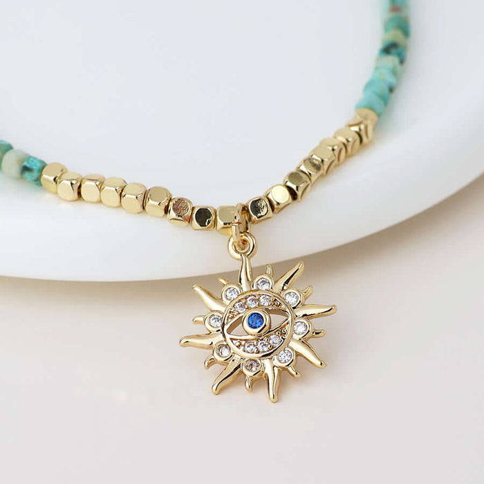 POM925 - Golden and turquoise bracelet with crystal sun charm