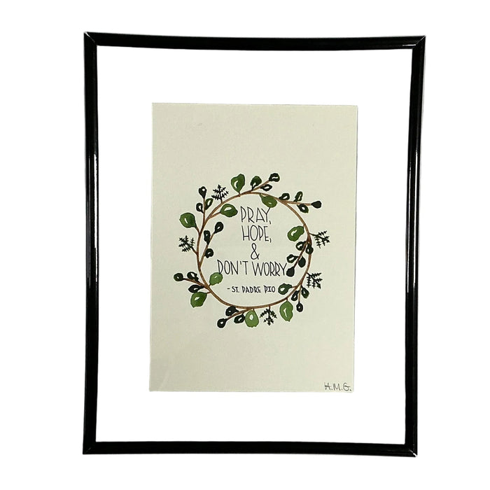 Framed artwork with a wreath design and text on a white background