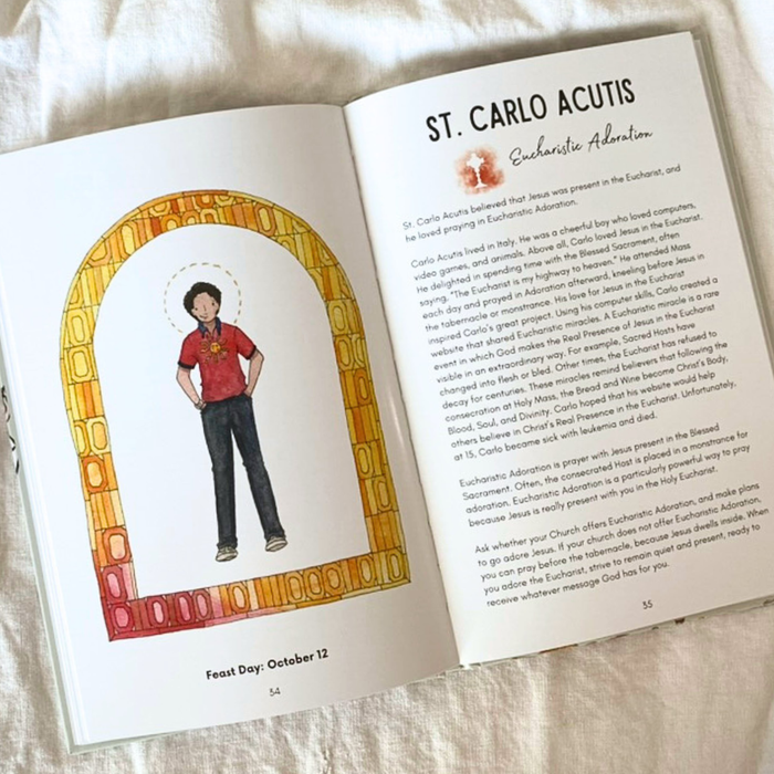 Open book with illustration of a person in a red shirt and dark pants, and text about St. Carlo Acutis.