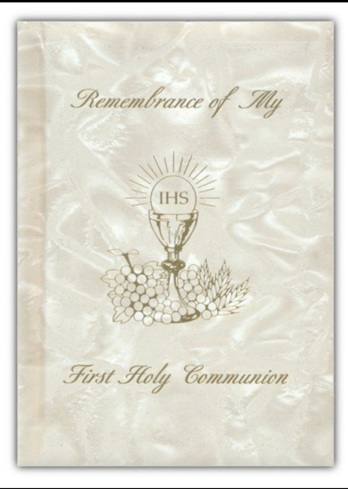 First Holy Communion book with chalice and grapes design on a textured beige background