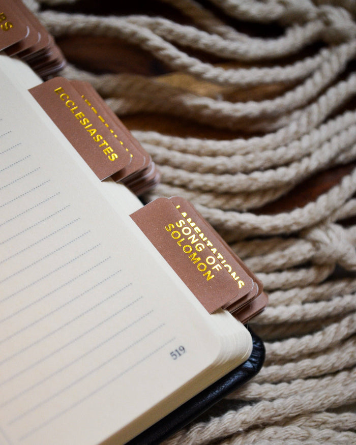 Notebook with brown bookmarks on a textured beige background