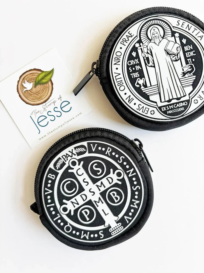 Two black and white pouches with religious designs on a white background.