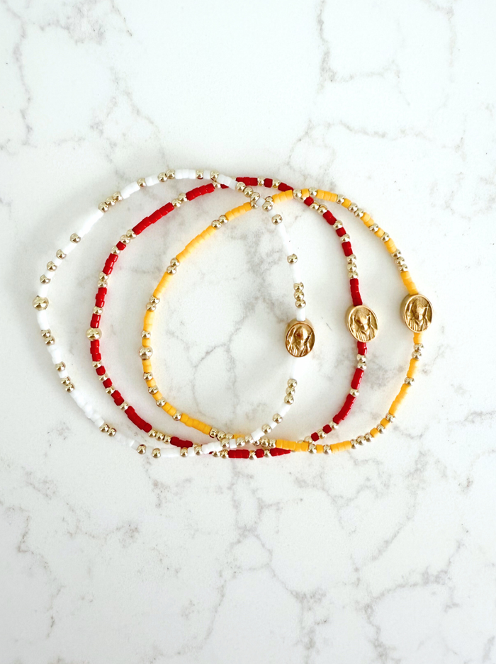Set of beaded necklaces on a marble surface