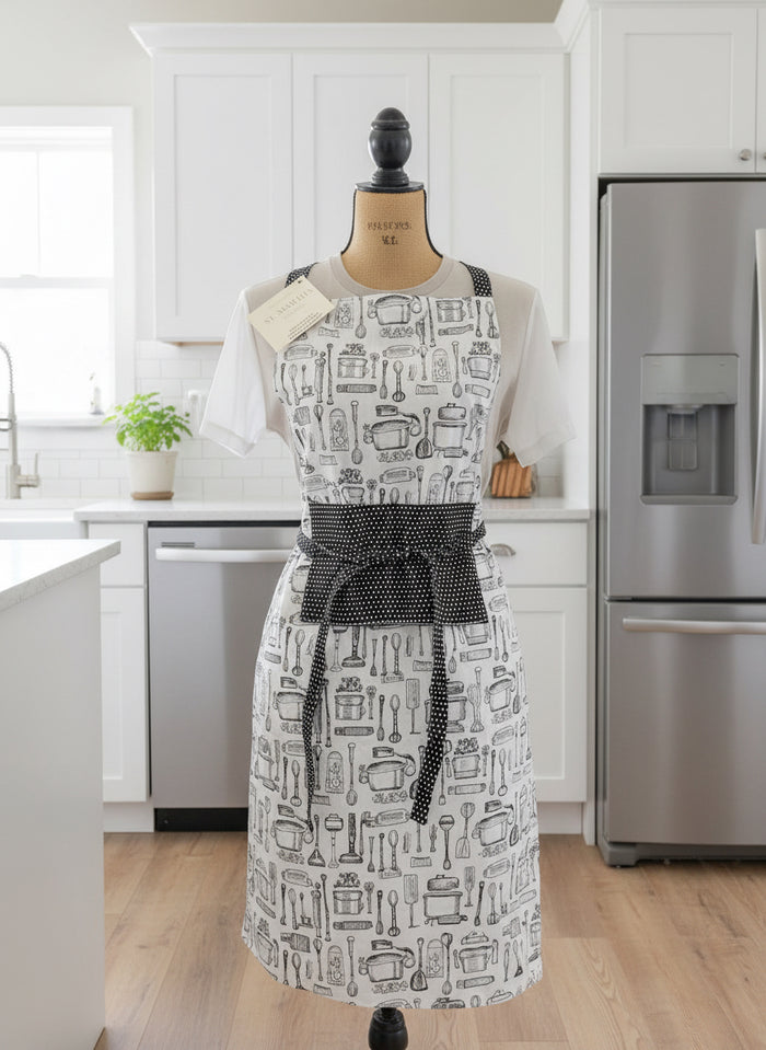 Silver apron with black belt on a mannequin against a neutral background