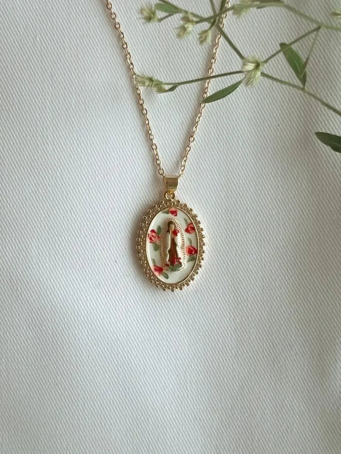 Necklace with a pendant featuring a religious design on a light background