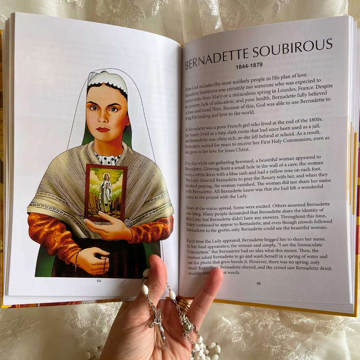 Open book with an illustration of Bernadette Soubirous and text, held by a hand with a rosary.