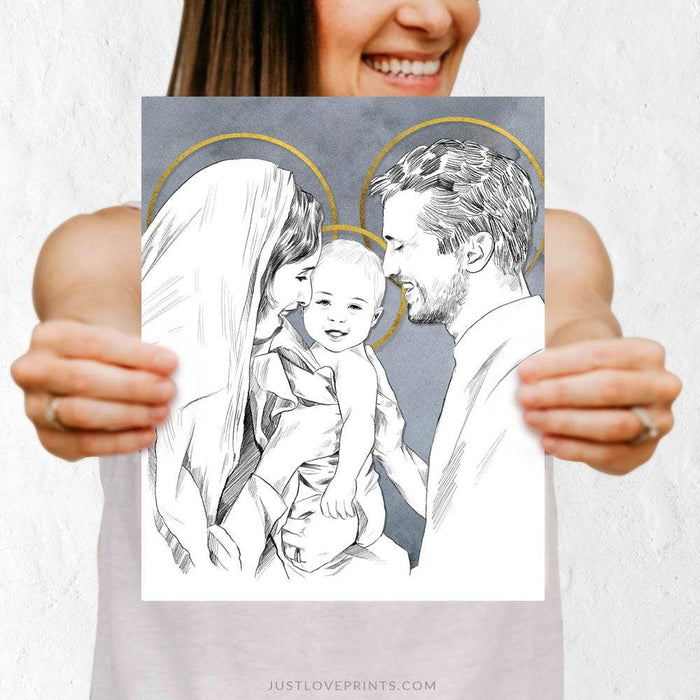 Person holding a black and white illustration of a family with 'Just Love Prints' branding.