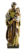 Statue of Saint Joseph holding baby Jesus on a white background