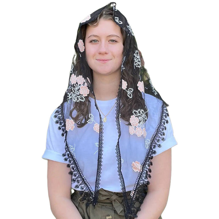 Woman wearing a floral embroidered veil on a white background