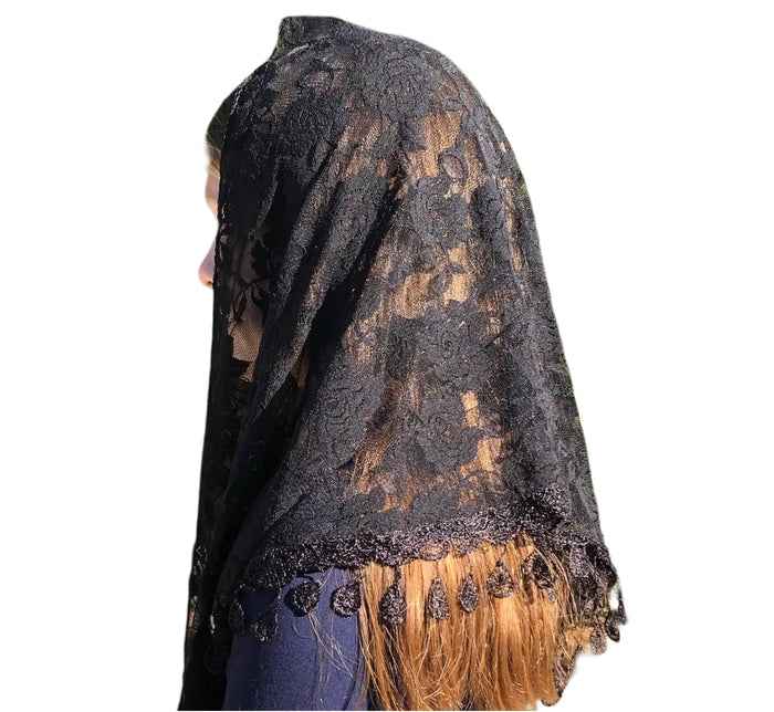 Black lace veil with gold accents and fringe on a white background