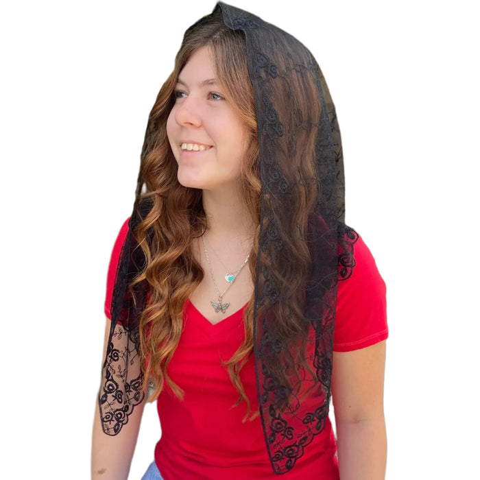 Woman wearing a black lace veil and red top on a white background