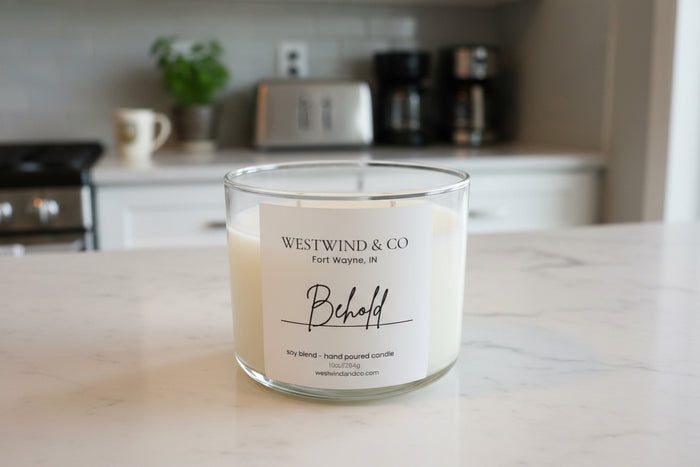 Glass candle with Westwind & Co label on a kitchen counter